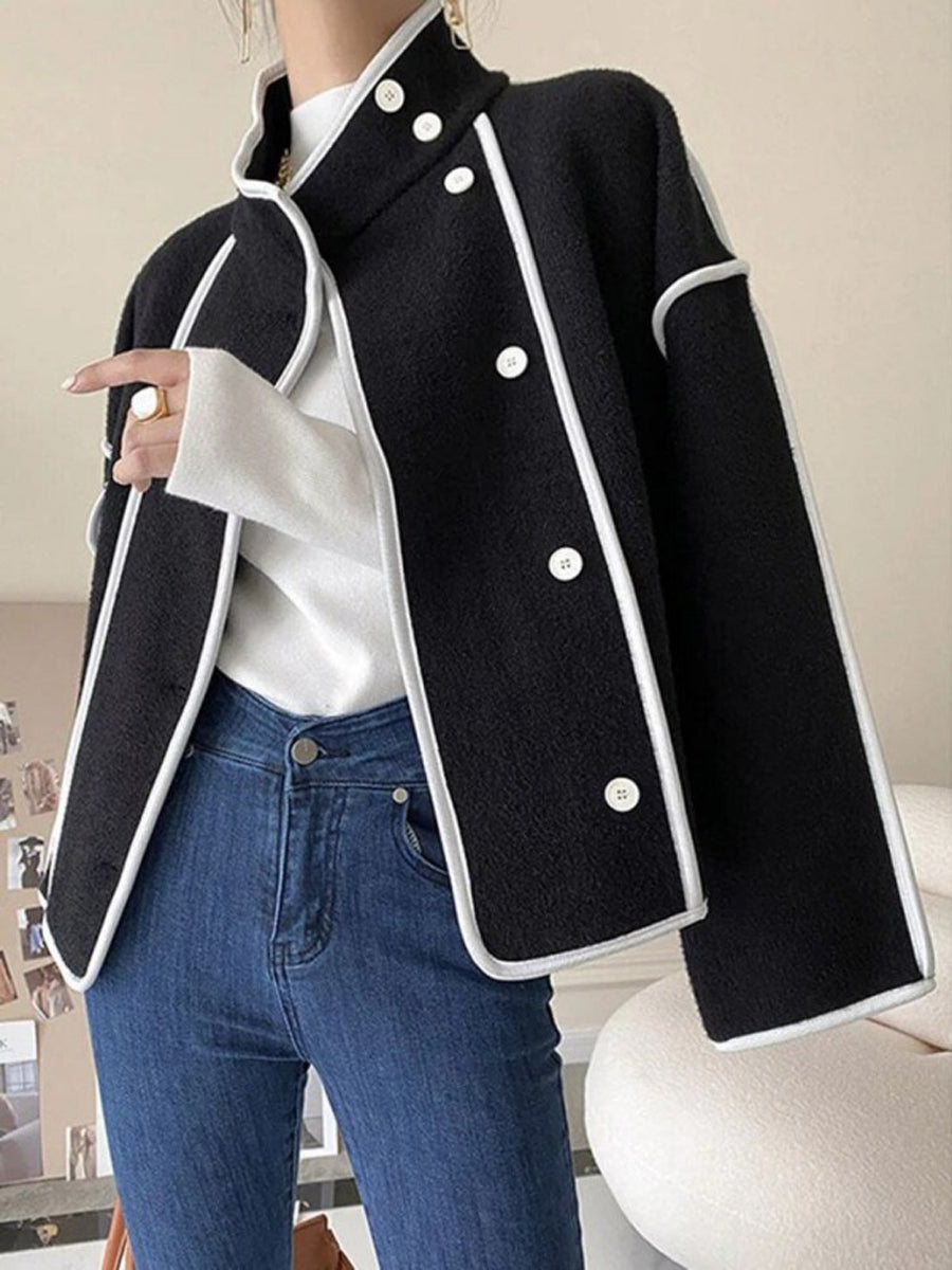 Boxy jacket with contrast piping along the seams and a stand collar in black