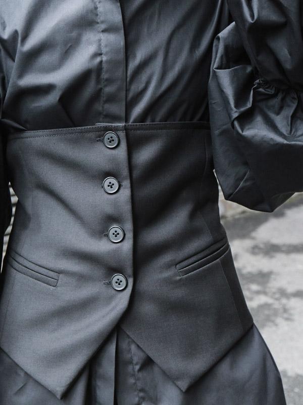 Strapless black cropped waistcoat with a button front and back belt