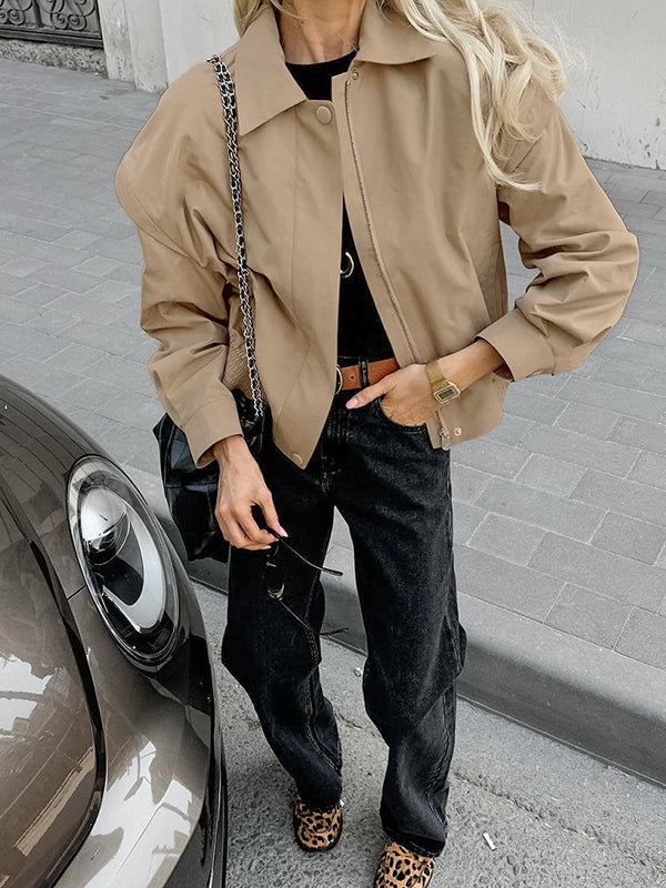 Boxy khaki utility jacket with a wide collar and flaps over the shoulder