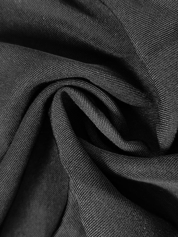 Floor-length black coat with a satin peak lapel and side splits