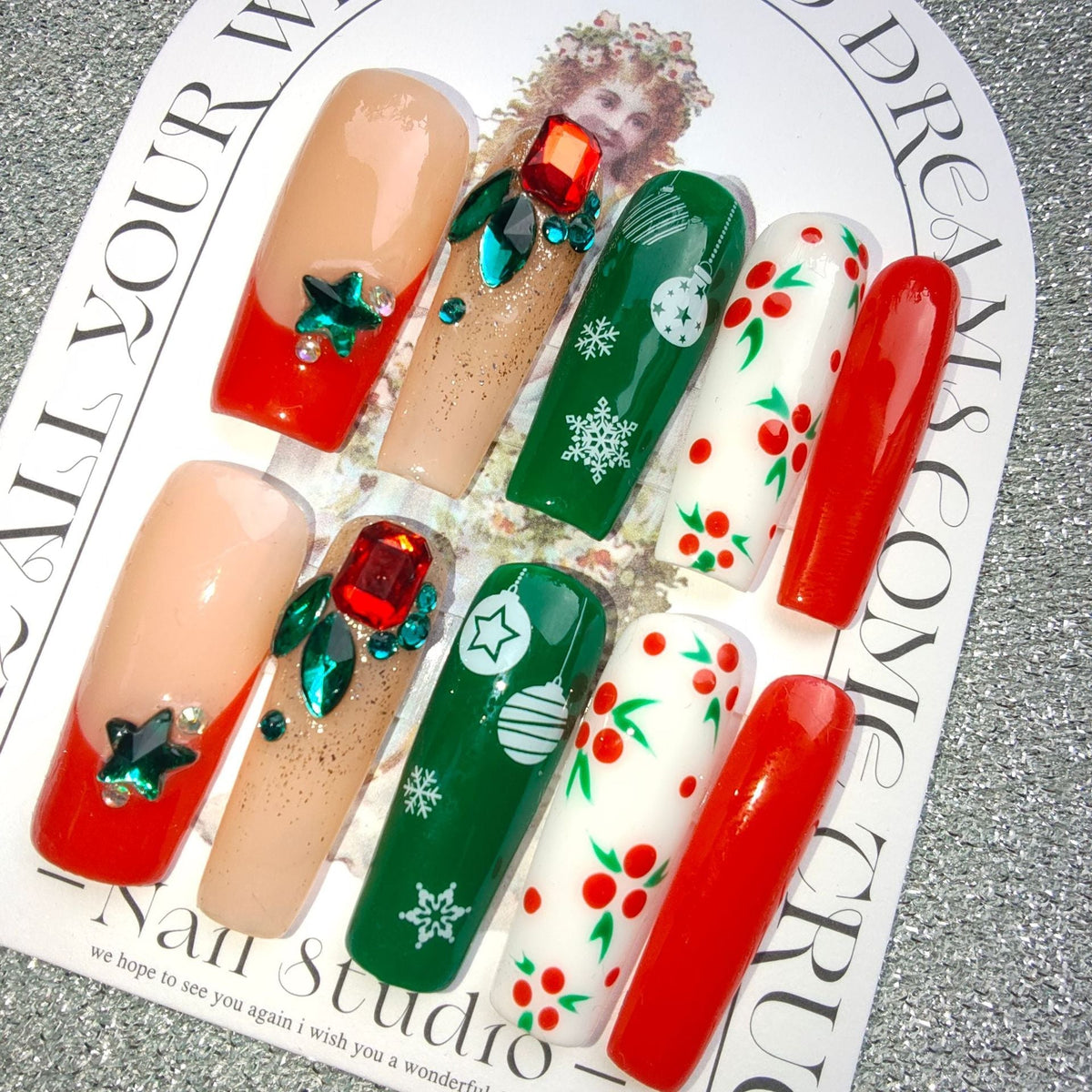 3D Christmas press-on nails with festive figures and bows on a display card - red and green with gems