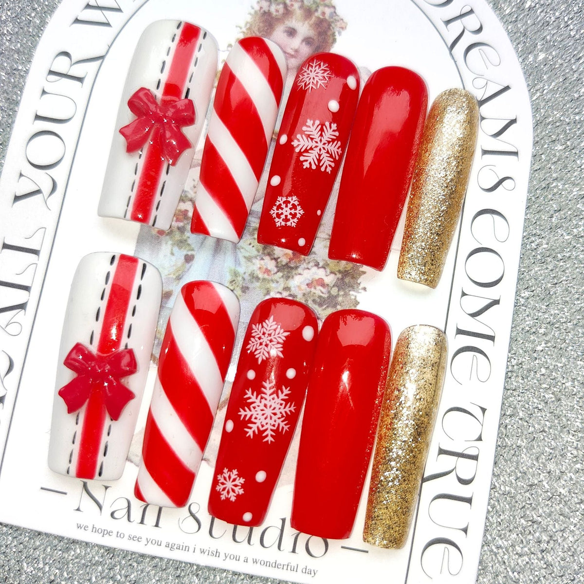 3D Christmas press-on nails with festive figures and bows on a display card - candy cane with bow and gold glitter