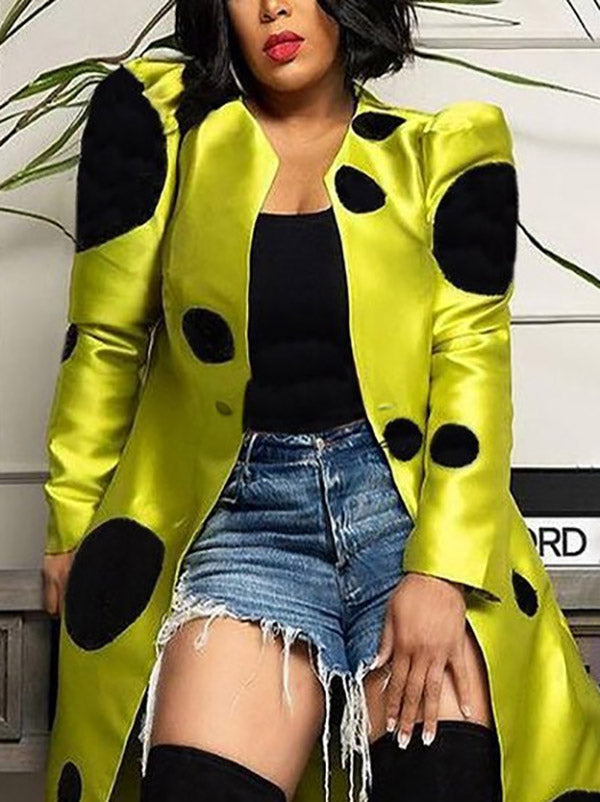 Yellow longline coat with large black polka dots and a round neck