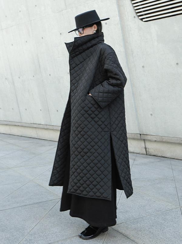 Long black quilted wrap coat with a fold-over collar and ring-buckle belt