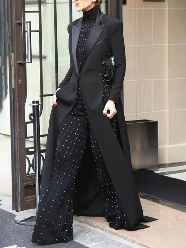 Floor-length black coat with a satin peak lapel and side splits