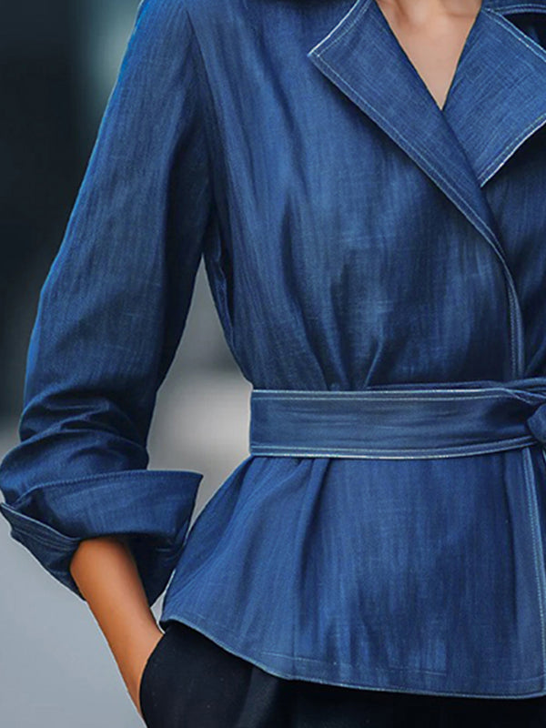 Blue denim jacket with a wide lapel collar and a sash tied at the waist