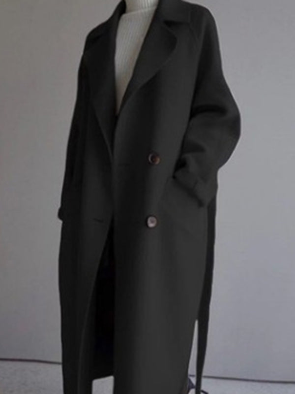 Belted longline coat with a notch lapel and welt pockets in black