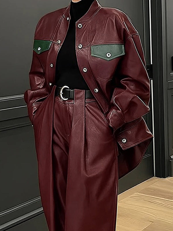 Oversized burgundy faux leather jacket with green contrast pocket flaps in burgundy
