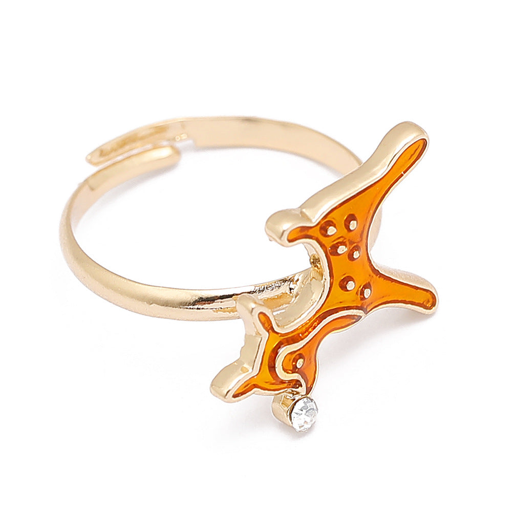 Adjustable gold-tone Christmas ring with an open band and a festive motif - leaping reindeer