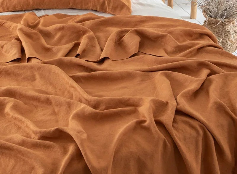 Airy woven sheet with a washed look on a bed - rust