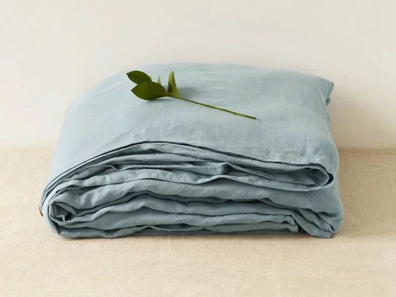 Airy woven sheet with a washed look on a bed - grey blue