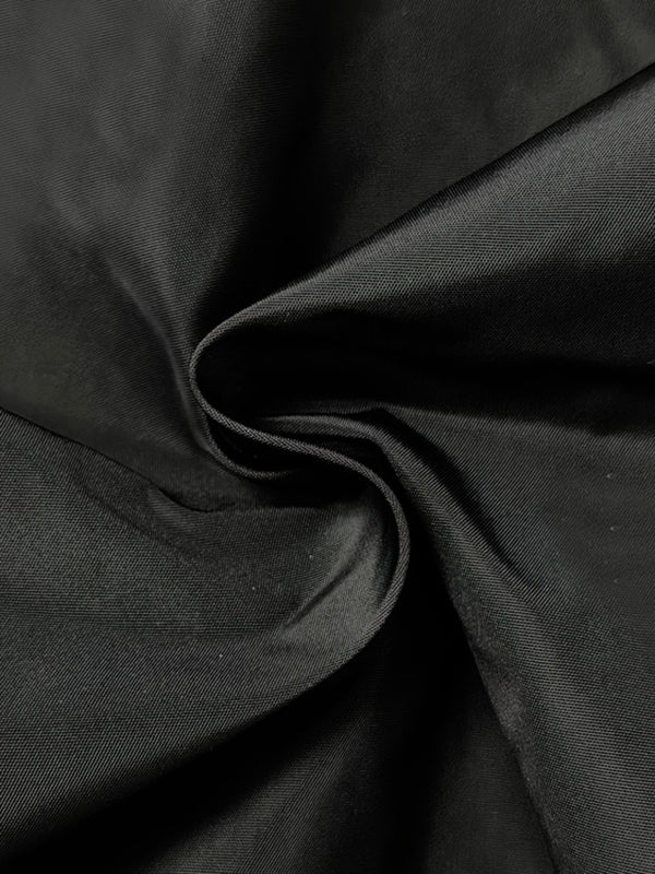Draped jacket with an asymmetric fold-over front and stand collar
