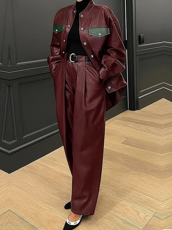 Oversized burgundy faux leather jacket with green contrast pocket flaps