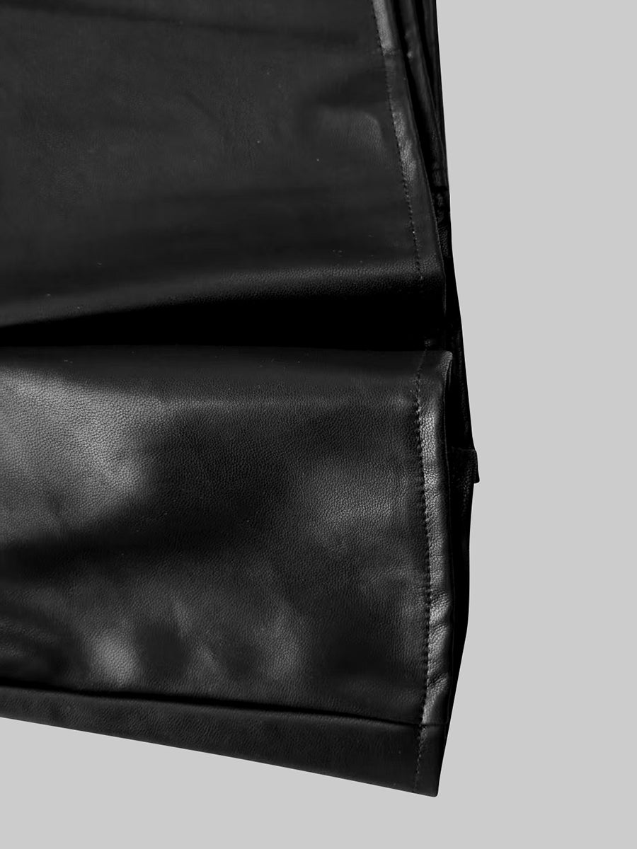 Fitted black faux leather blazer with a peak lapel and gold-tone buttons