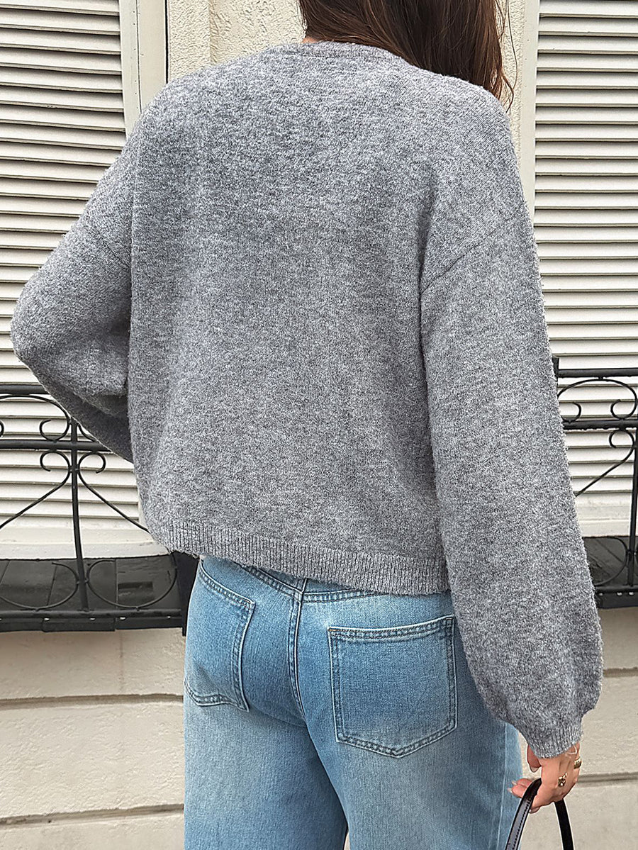Soft grey knitted cardigan with a tie fastening at the neck