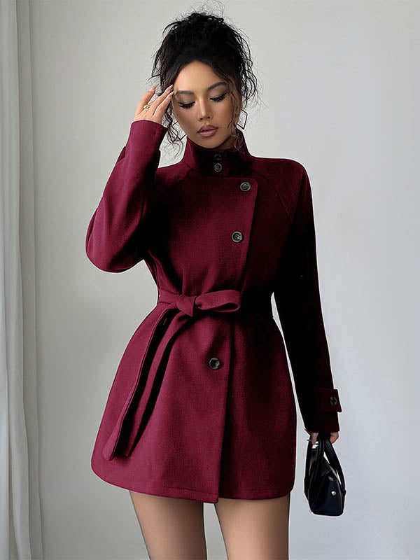 Short belted coat with a stand collar and an asymmetric button front