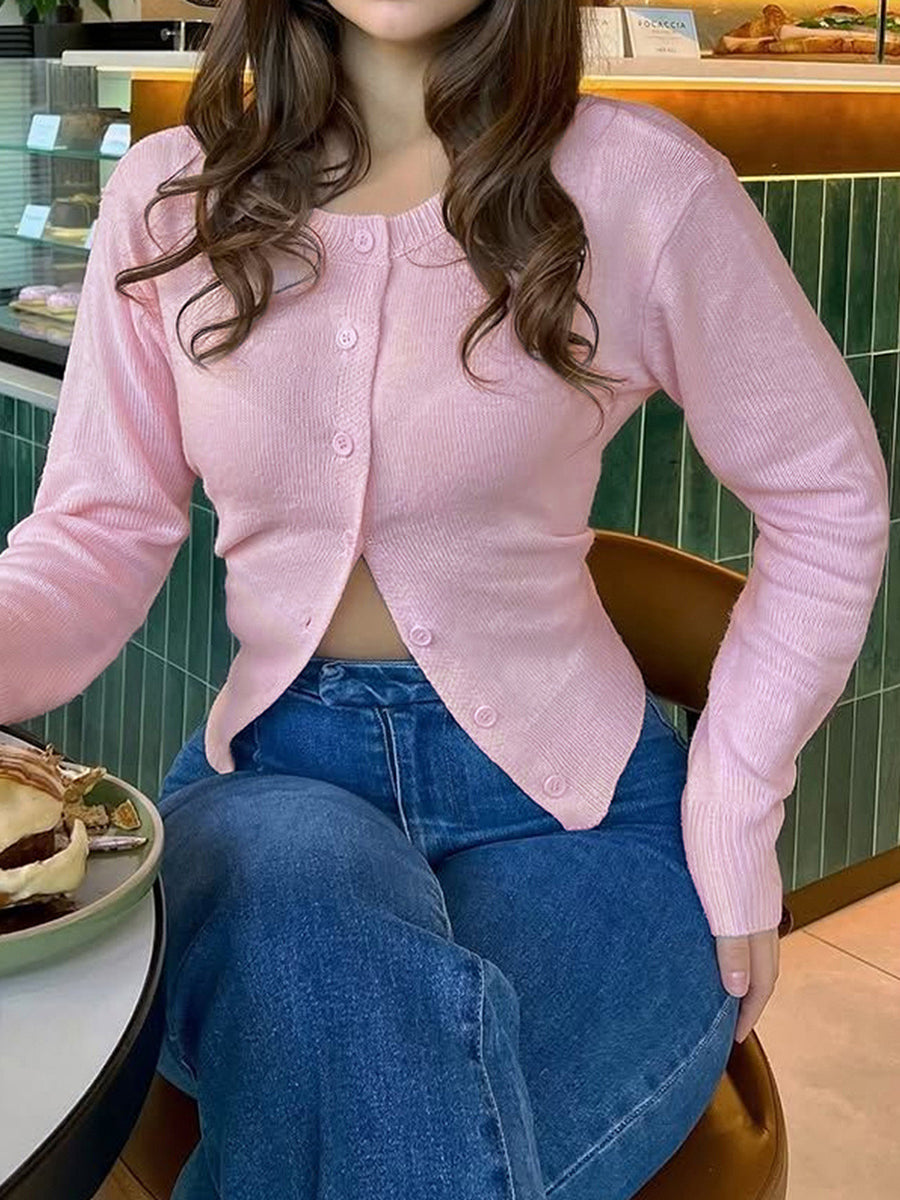 Soft pink knitted jacket with a round neck and button front in soft pink