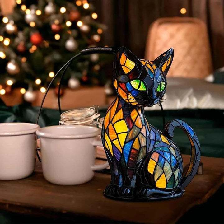 Black cat lamp in a stained glass look with green eyes and blue, orange and yellow panels