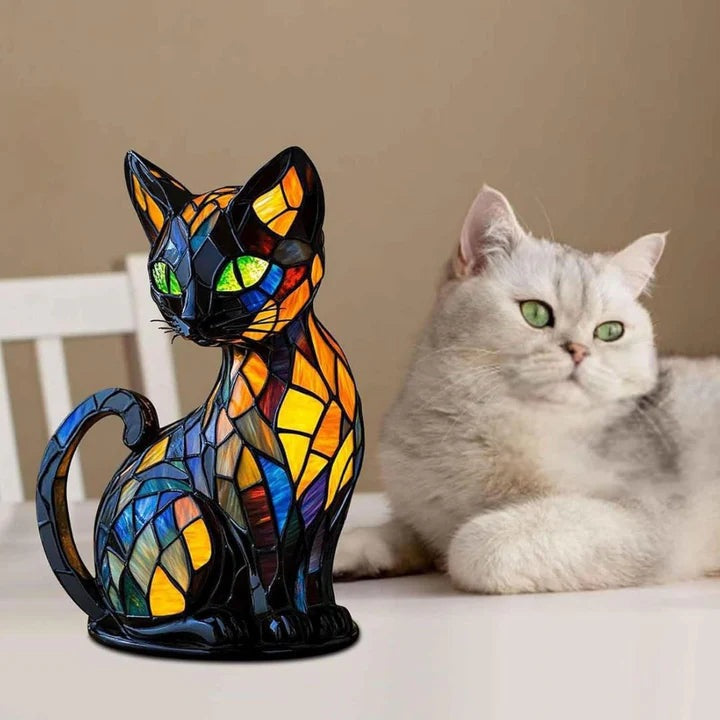 Black cat lamp in a stained glass look with green eyes and blue, orange and yellow panels
