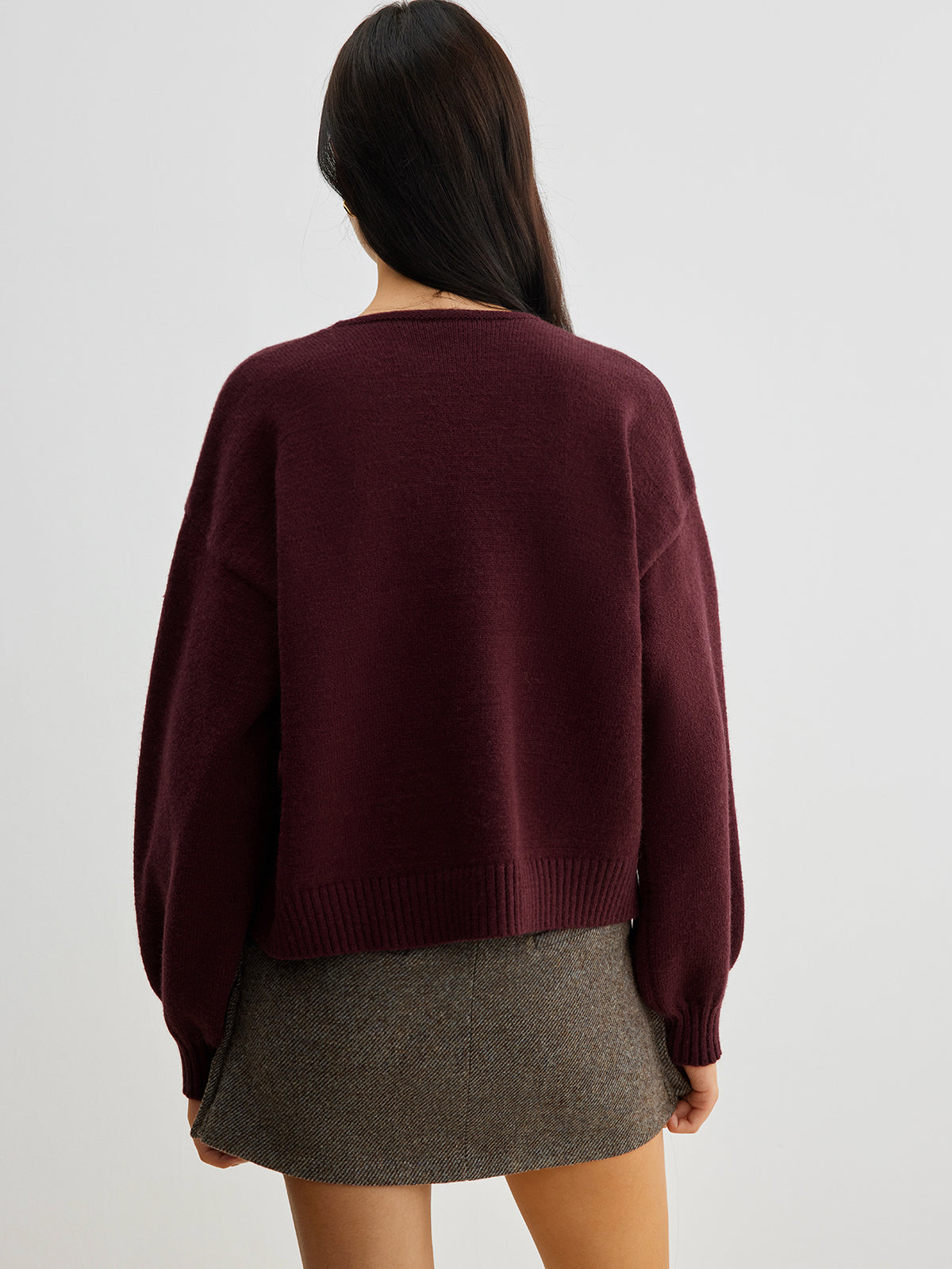 Women's short cardigan with three black bows and a crew neck
