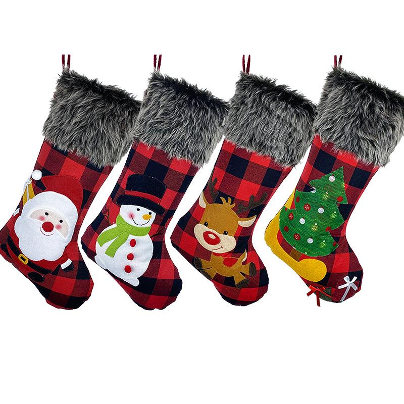 Red and black buffalo check Christmas stocking with a grey faux fur cuff