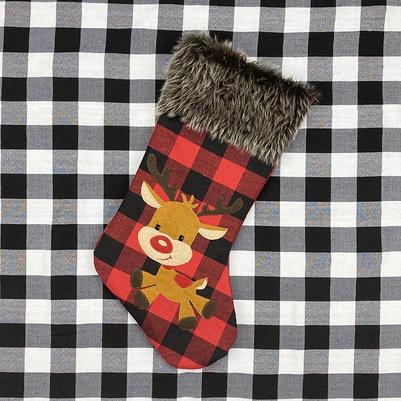 Red and black buffalo check Christmas stocking with a grey faux fur cuff - reindeer