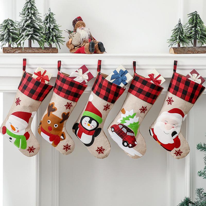 Burlap-look Christmas stocking with a red and black check cuff and a character