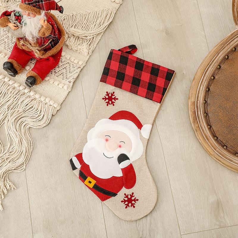 Burlap-look Christmas stocking with a red and black check cuff and a character - father christmas