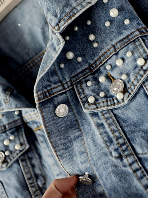 Light wash denim jacket with pearl-effect studs on the shoulders