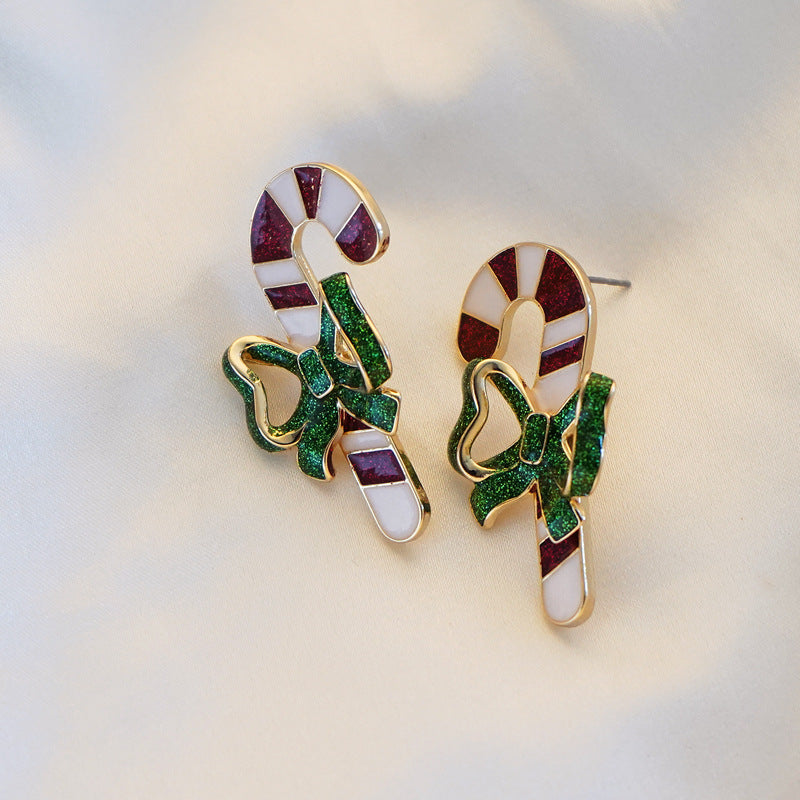 Candy cane Christmas stud earrings with a green glitter bow and gold-tone edge