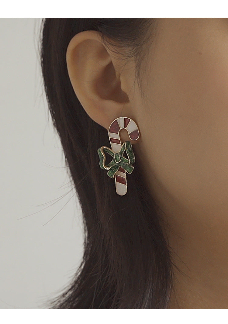 Candy cane Christmas stud earrings with a green glitter bow and gold-tone edge