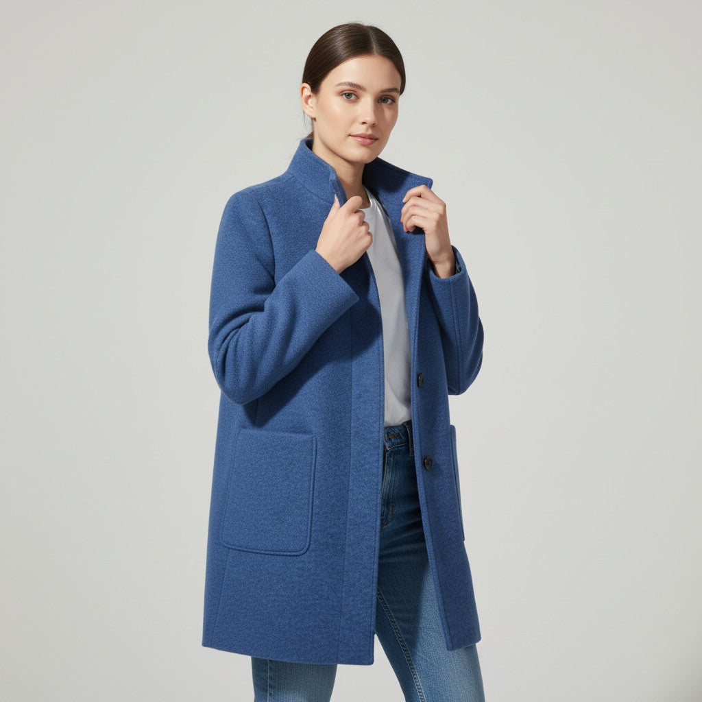 Knee-length single-breasted coat with a stand collar and patch pockets in blue
