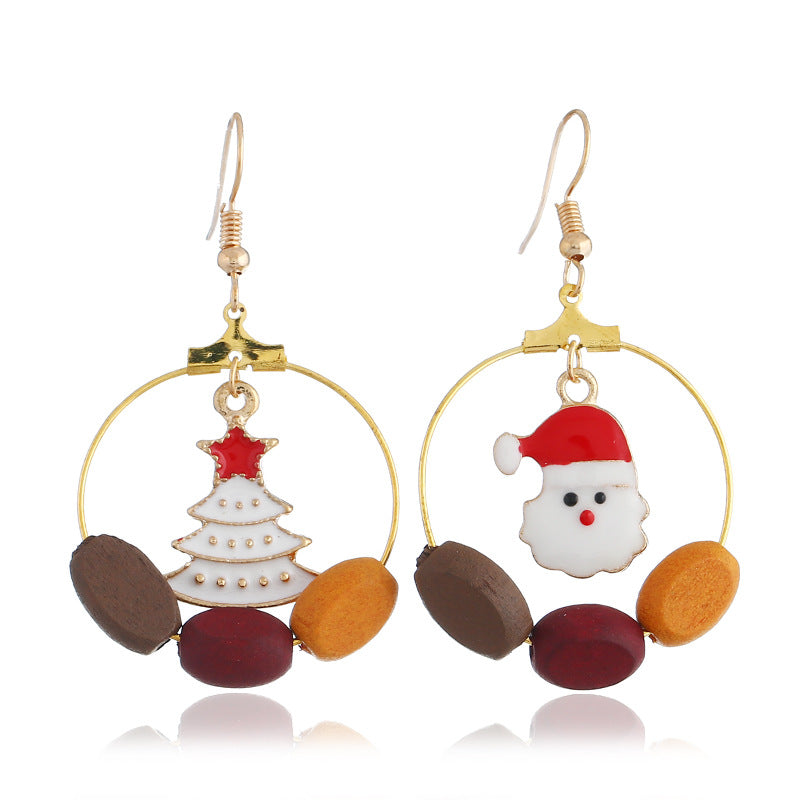 Gold-tone Christmas hoop earrings with beads and a festive charm inside the hoop - tree and father christmas