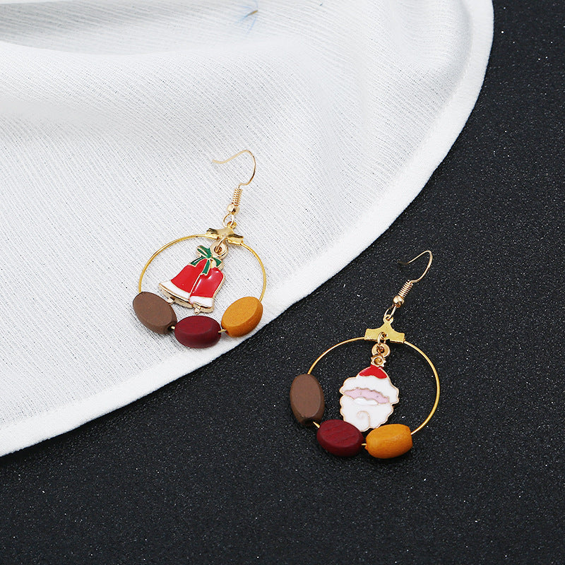 Gold-tone Christmas hoop earrings with beads and a festive charm inside the hoop