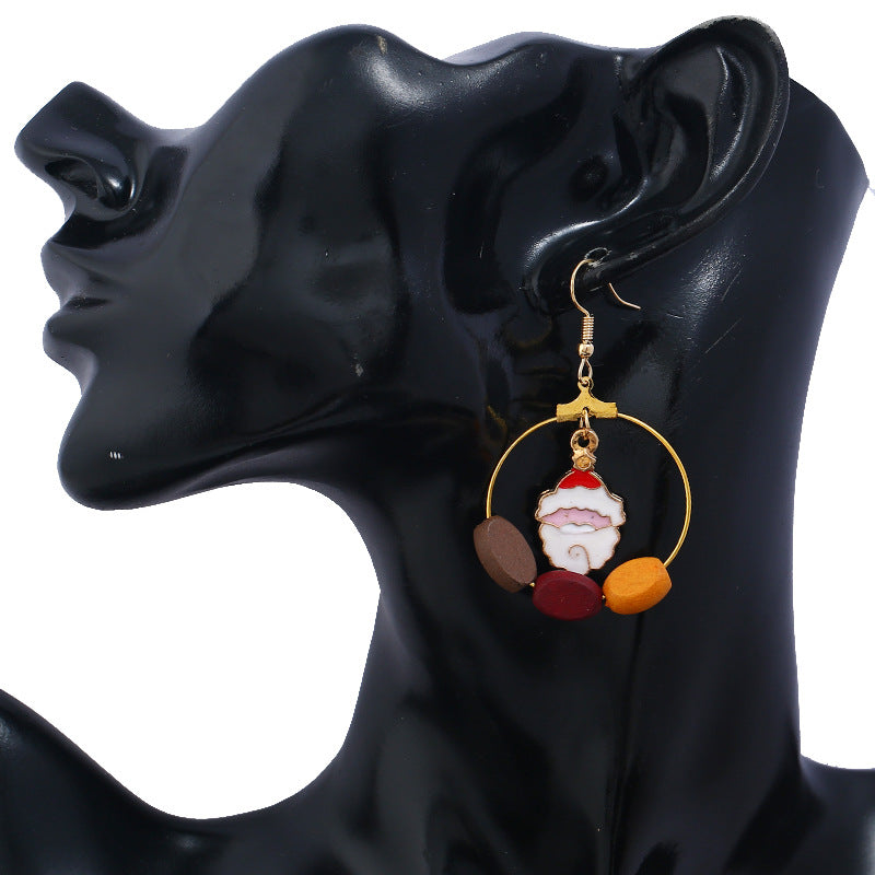 Gold-tone Christmas hoop earrings with beads and a festive charm inside the hoop