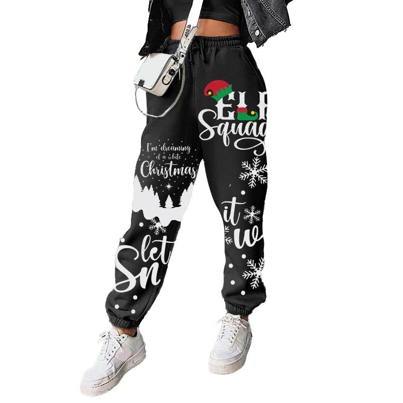 Women's Christmas joggers with elastic waist, cuffed ankles and festive print - black christmas slogan