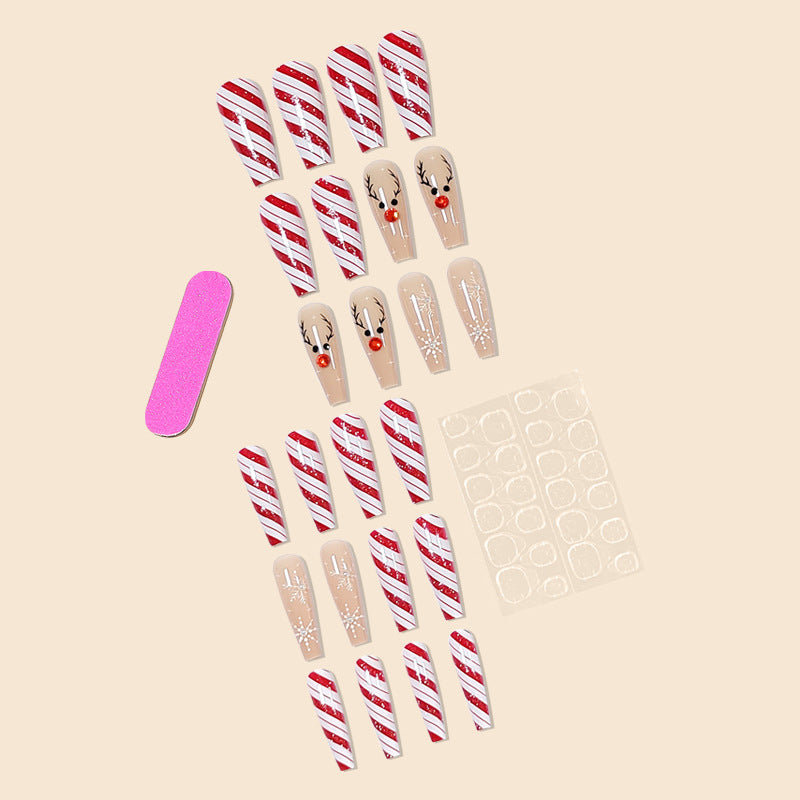 Christmas press-on nails with a festive print, applied on a hand
