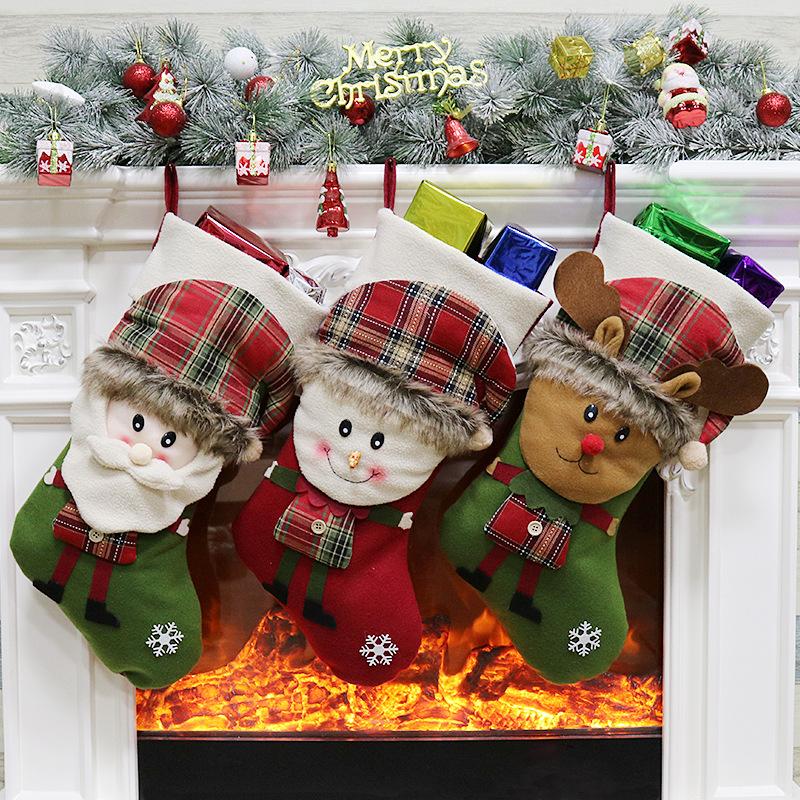 Christmas stocking with a 3D figure in a tartan hat and a white cuff by the fire