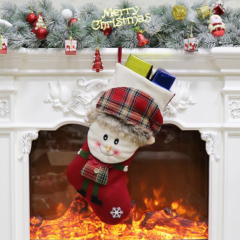 Christmas stocking with a 3D figure in a tartan hat and a white cuff by the fire