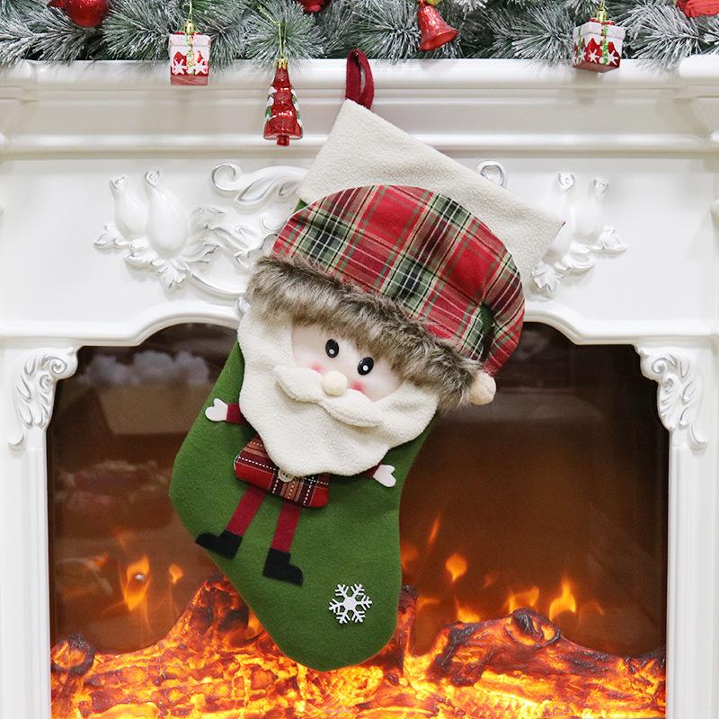 Christmas stocking with a 3D figure in a tartan hat and a white cuff by the fire - father christmas on green