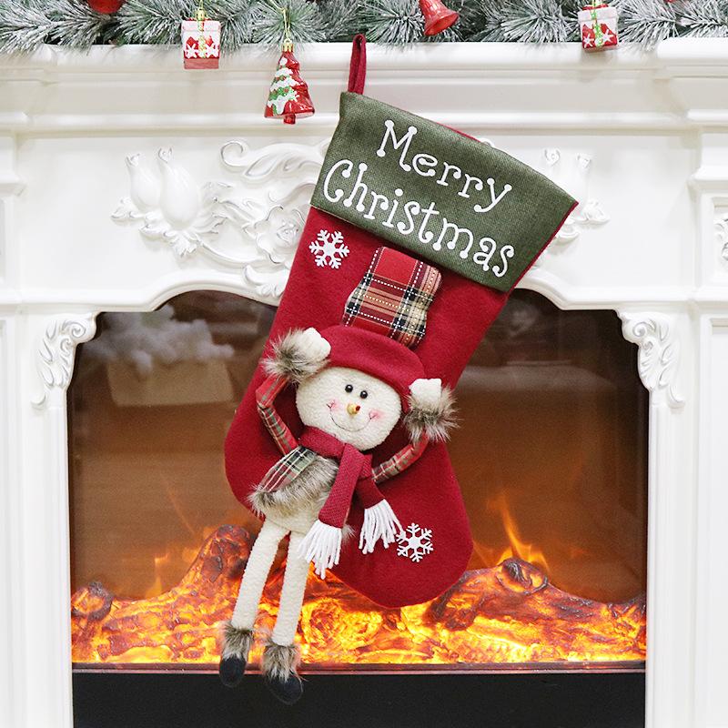 Large Christmas stocking with a dangling-leg character and Merry Christmas cuff - snowman