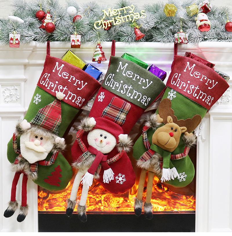Large Christmas stocking with a dangling-leg character and Merry Christmas cuff