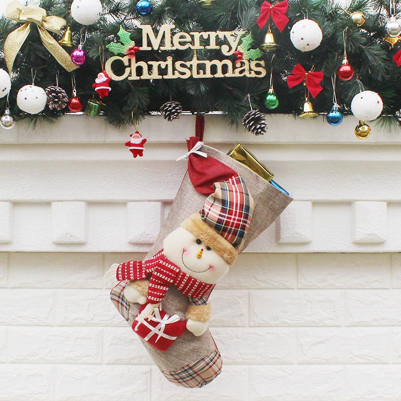 Christmas stocking with a plush figure and check toe hanging from a mantelpiece