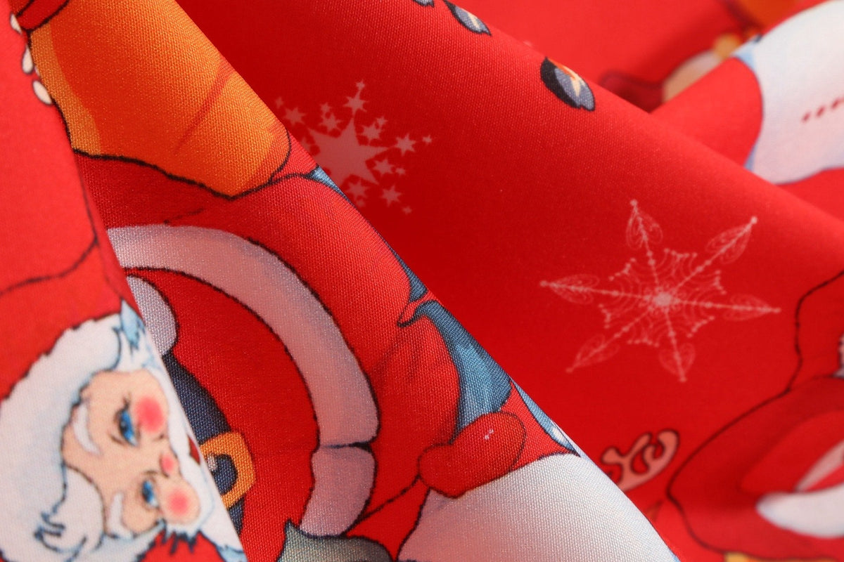 Women's Christmas swing dress with black bodice, bow belt and festive print