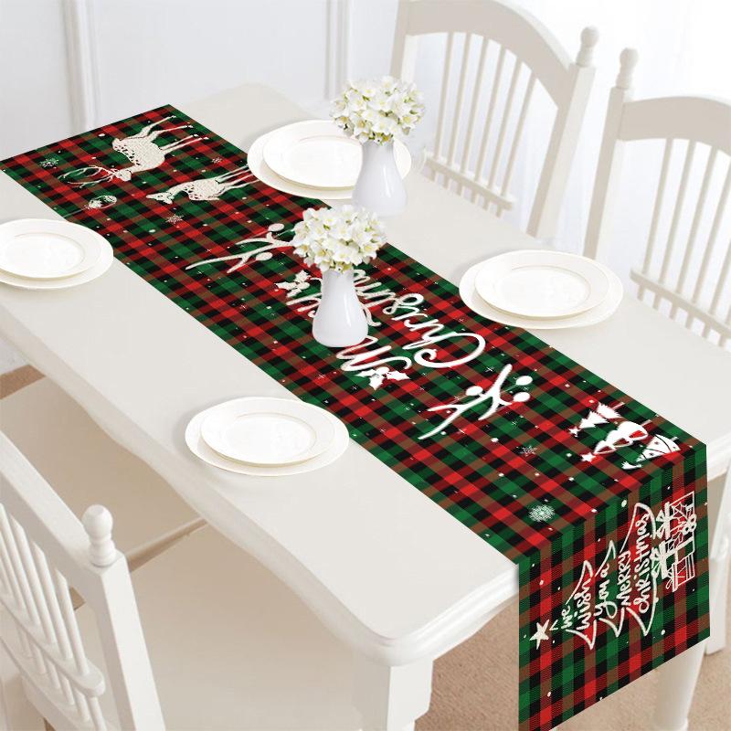 Christmas table runner, 30 x 180 cm, with a festive print on a laid table - green and red tartan