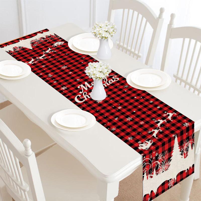 Christmas table runner, 30 x 180 cm, with a festive print on a laid table - red check with reindeer