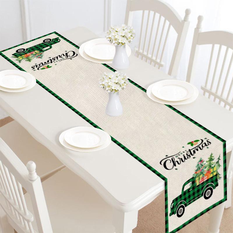 Christmas table runner, 30 x 180 cm, with a festive print on a laid table - beige with green christmas truck