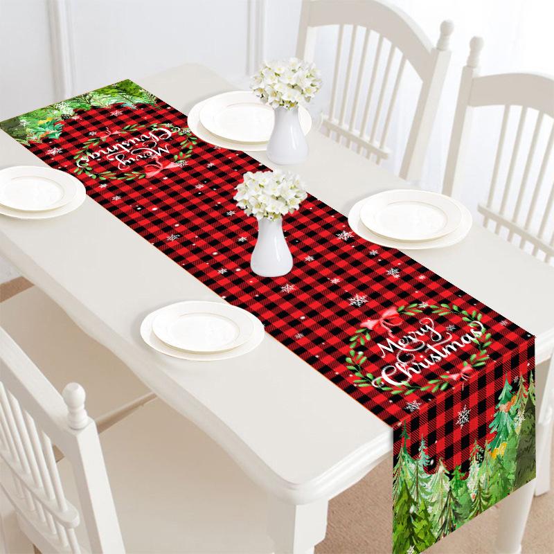 Christmas table runner, 30 x 180 cm, with a festive print on a laid table - red check with wreath