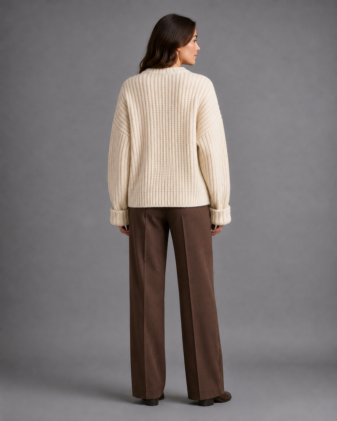 Women's chunky cable knit cardigan with a V-neck and dark buttons