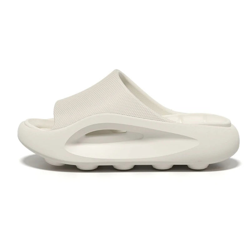 EVA sliders with a thick sole, contoured footbed and wide band across the instep - white